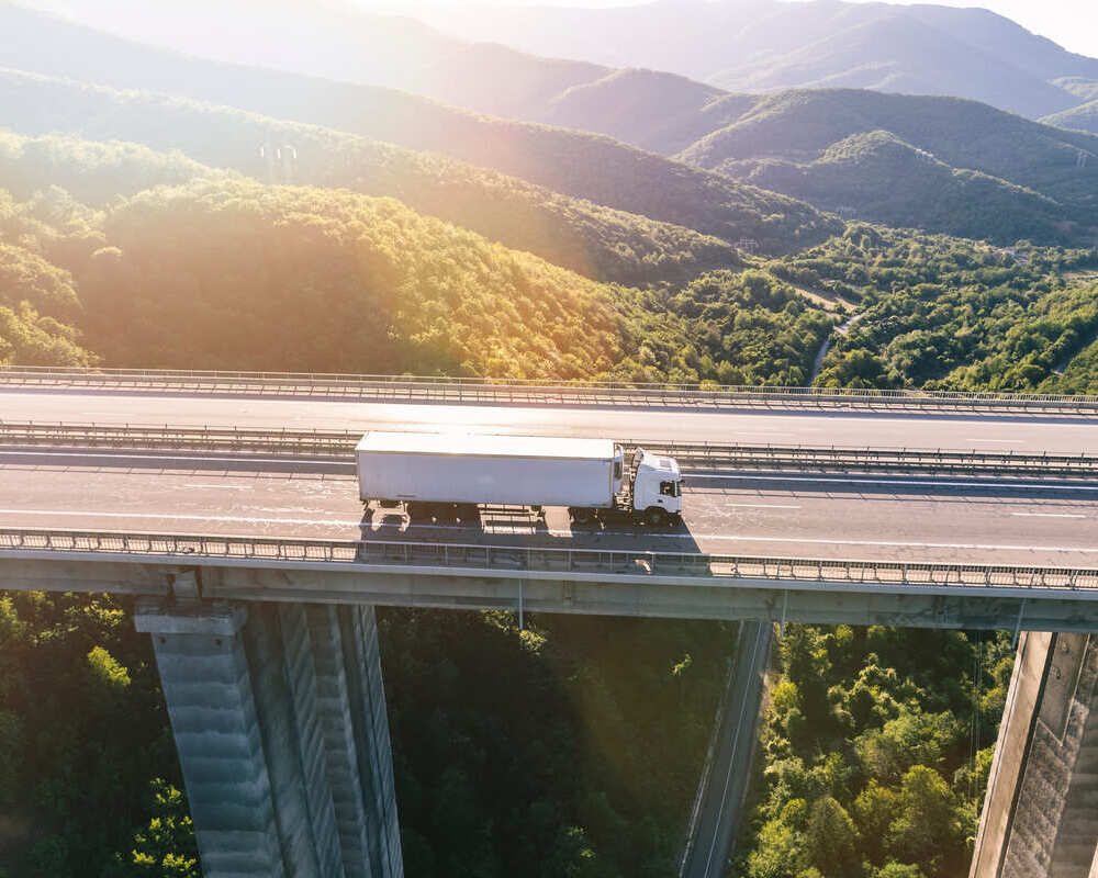 trucks-on-highway-in-mountain-at-sunset-2023-11-27-05-21-08-utc (1) (1) (1) (1)